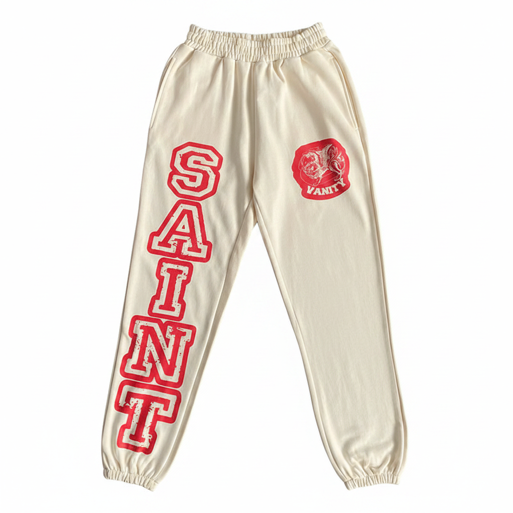 SAINT VANITY Cream Varsity Print Jogger Sweatpants - White Background Flat Lay Front